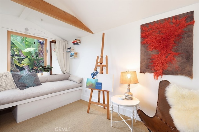 sitting room featuring carpet flooring and vaulted ceiling with beams