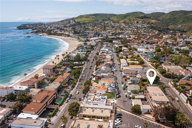 drone / aerial view with a view of the beach and a water and mountain view