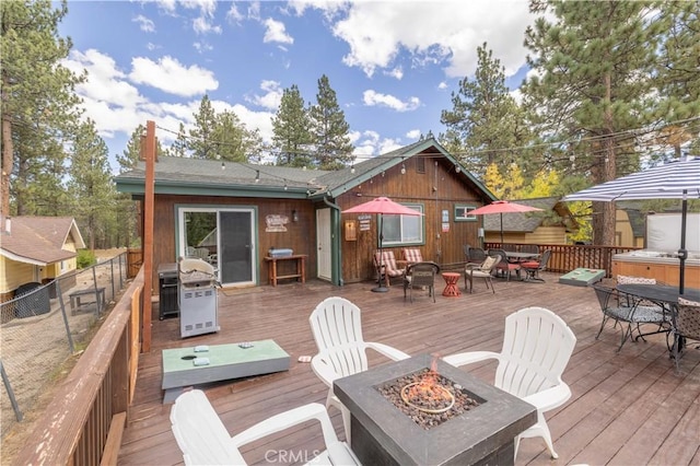 wooden terrace featuring an outdoor fire pit