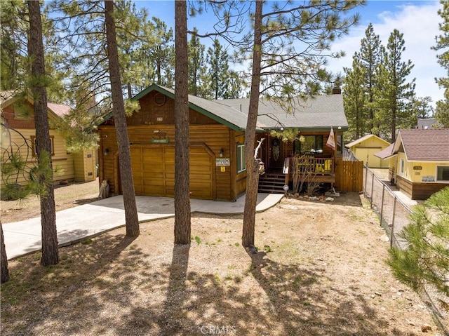 rear view of house with covered porch and a garage