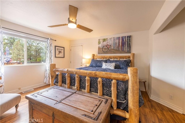 bedroom with dark hardwood / wood-style floors and ceiling fan