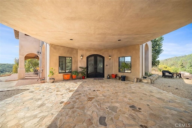 doorway to property with a patio area and french doors