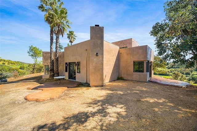 back of property with a patio