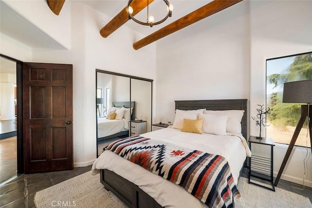 bedroom featuring a high ceiling, ceiling fan with notable chandelier, and beam ceiling