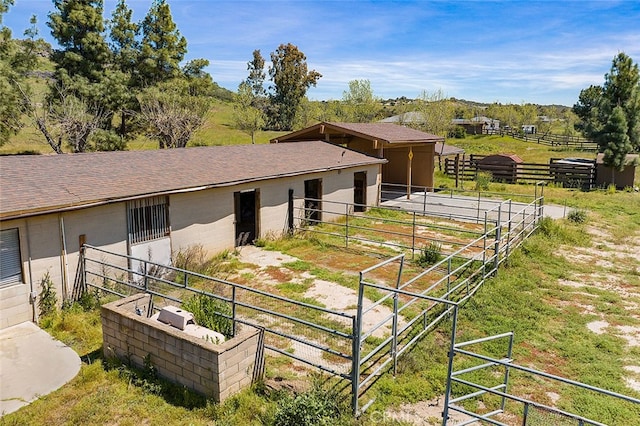 view of stable with a rural view