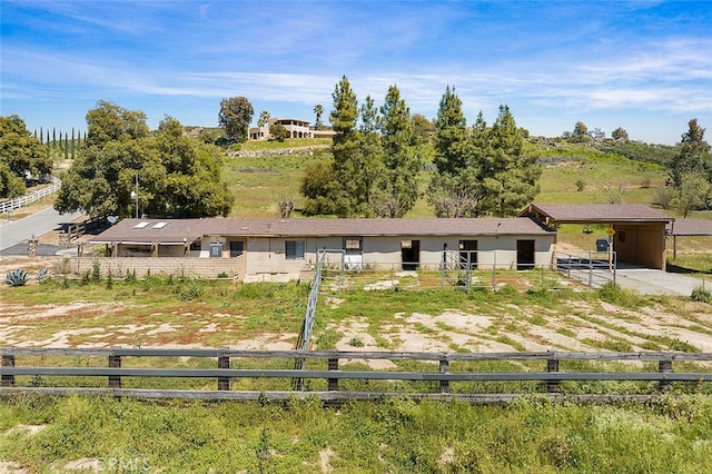 ranch-style house featuring a rural view and an outbuilding