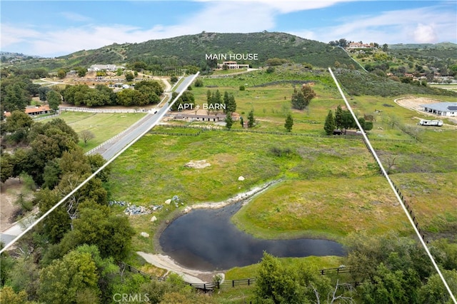 aerial view featuring a water and mountain view and a rural view