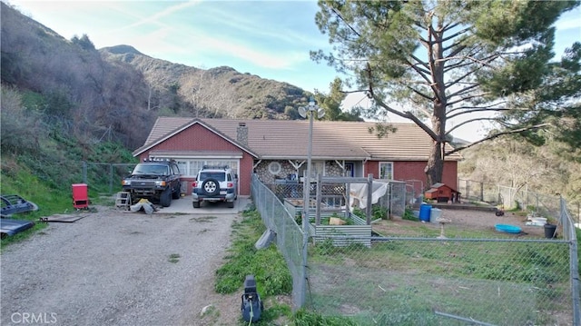 single story home featuring a garage and a mountain view