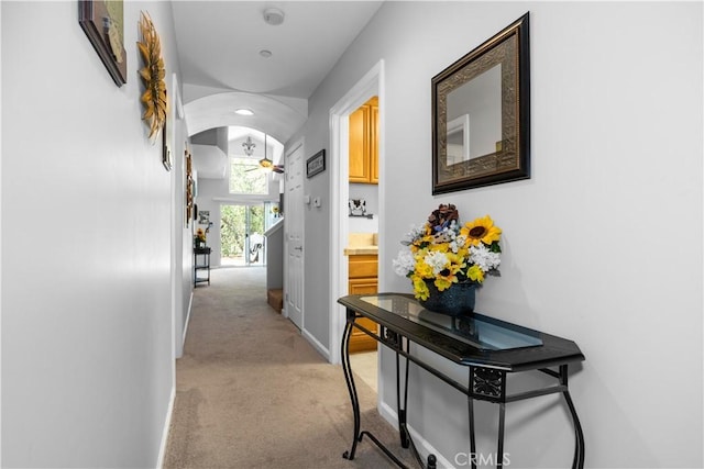 hallway with light colored carpet