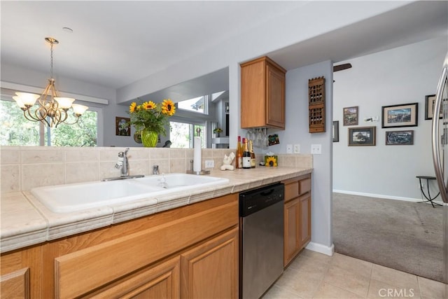 kitchen with tile countertops, sink, stainless steel dishwasher, and light colored carpet