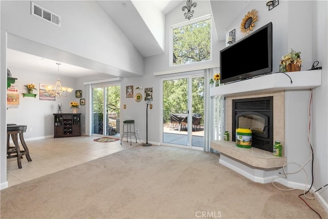 living room with an inviting chandelier, a towering ceiling, and carpet floors