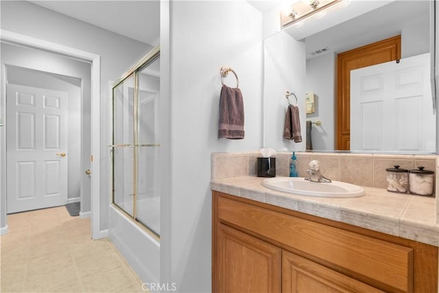 bathroom featuring enclosed tub / shower combo and vanity