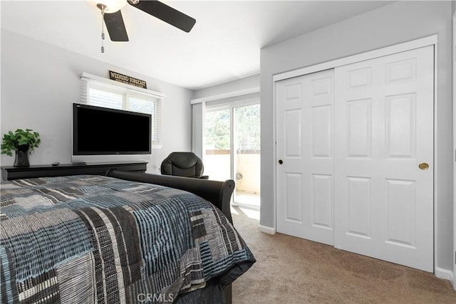 carpeted bedroom featuring access to exterior, ceiling fan, and a closet