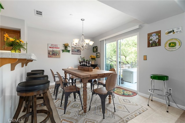 tiled dining area with an inviting chandelier