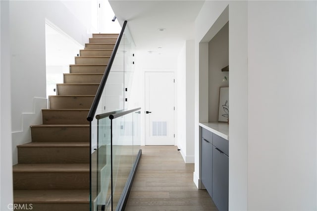 stairway featuring wood-type flooring