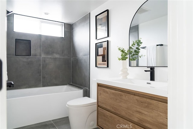 full bathroom featuring tile patterned floors, tiled shower / bath combo, vanity, and toilet