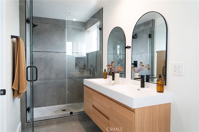 bathroom featuring walk in shower and vanity