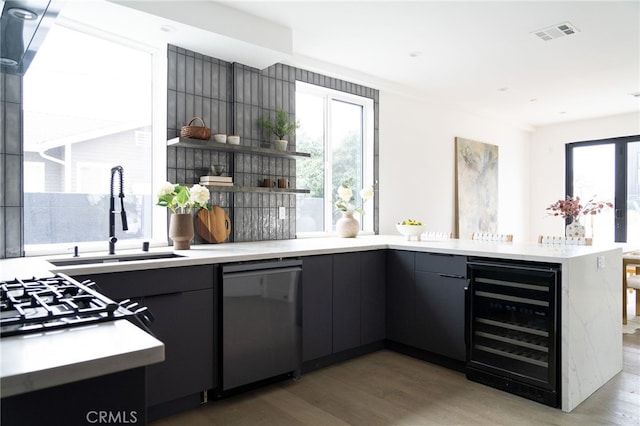 kitchen with wine cooler, dark hardwood / wood-style floors, dishwasher, and sink