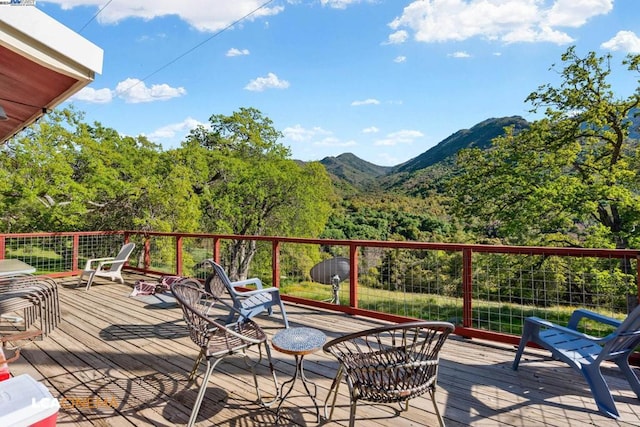 wooden deck with a mountain view