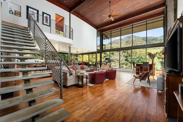 living room featuring hardwood / wood-style floors, a high ceiling, and wooden ceiling