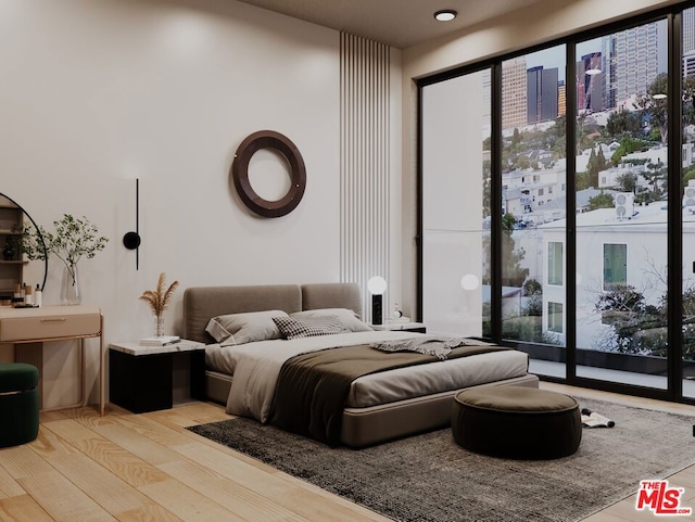 bedroom featuring light wood-type flooring and access to exterior