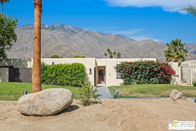 southwest-style home featuring a mountain view and a front yard