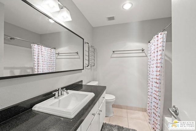 bathroom with tile patterned floors, walk in shower, vanity, and toilet