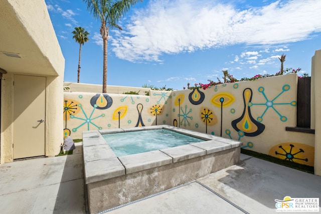 view of swimming pool featuring an in ground hot tub