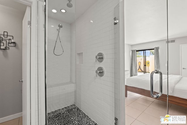 bathroom featuring an enclosed shower and tile patterned floors