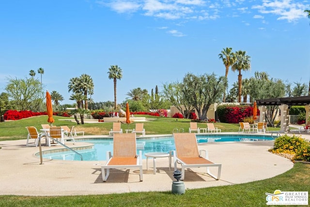 view of swimming pool with a patio and a yard