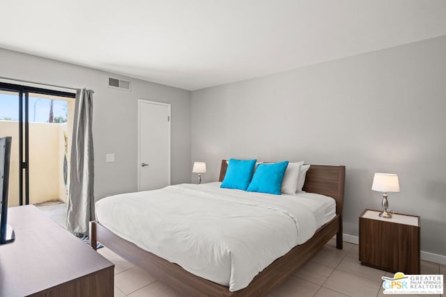 bedroom with light tile patterned floors