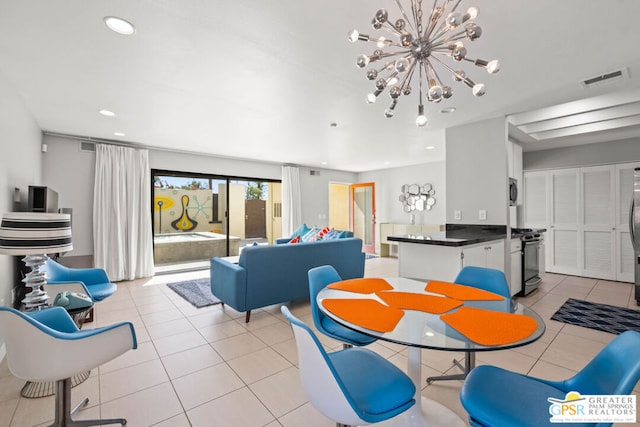 dining space featuring an inviting chandelier and light tile patterned flooring