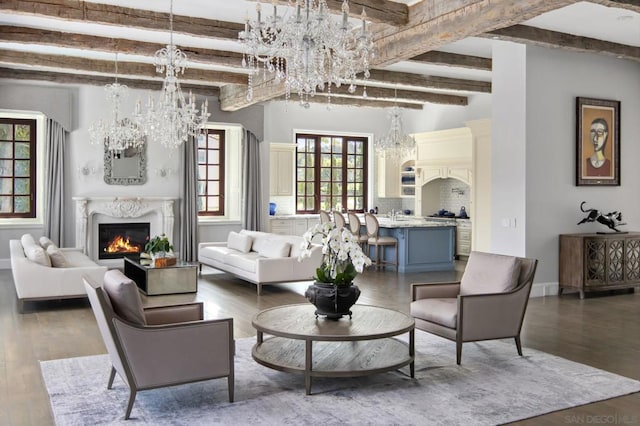 living room with beam ceiling, dark hardwood / wood-style flooring, and plenty of natural light