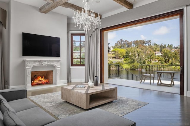 living room featuring beamed ceiling, a chandelier, and hardwood / wood-style floors