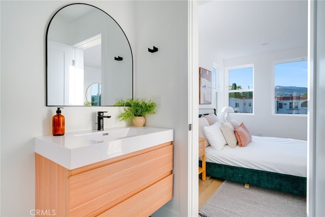 bedroom featuring sink and hardwood / wood-style flooring