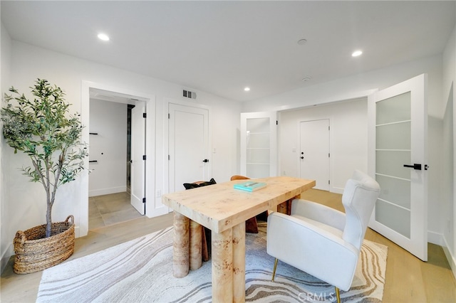 dining space with light hardwood / wood-style floors