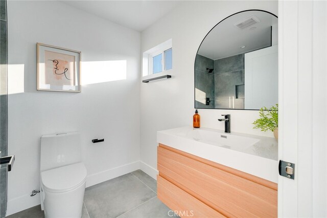 bathroom with vanity, toilet, and tile patterned flooring