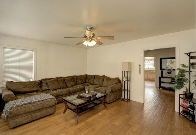 living room with light wood-type flooring and ceiling fan