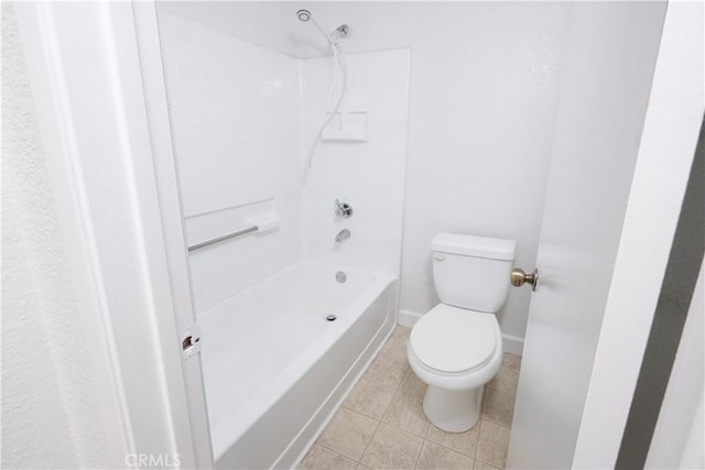 bathroom featuring tile patterned flooring, toilet, and shower / bathing tub combination