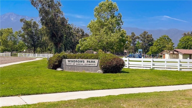 community sign with a lawn and a mountain view