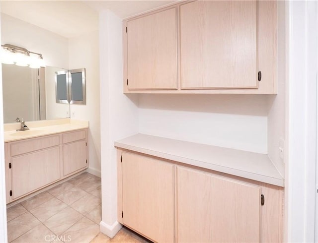 bathroom with tile patterned flooring and vanity