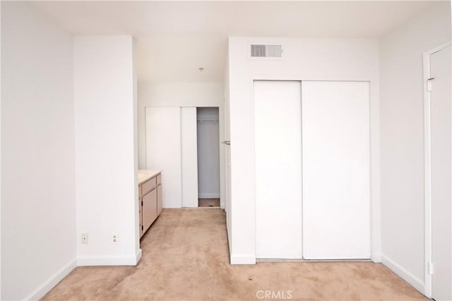 unfurnished bedroom featuring light carpet