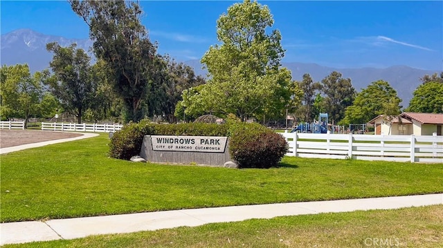 community sign with a lawn and a mountain view