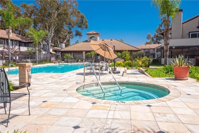 view of pool featuring a patio area and a hot tub