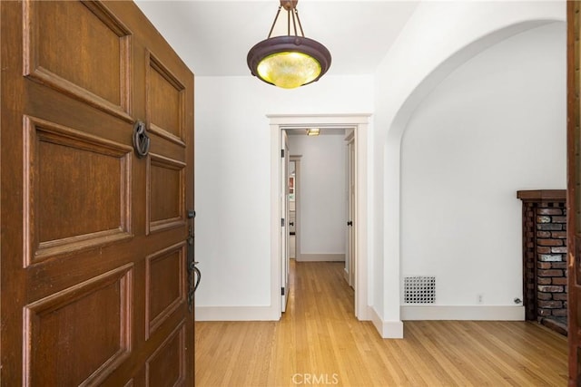 hallway with light hardwood / wood-style floors