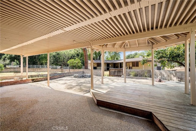 view of patio / terrace with a deck and an outdoor fire pit