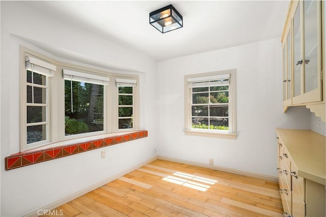 unfurnished dining area with light hardwood / wood-style floors