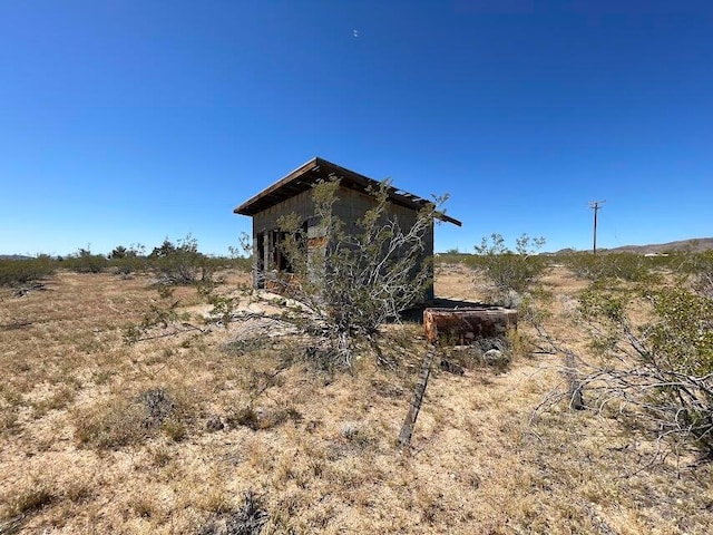 view of side of home featuring a rural view