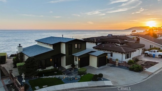 view of front facade featuring a water view and a garage