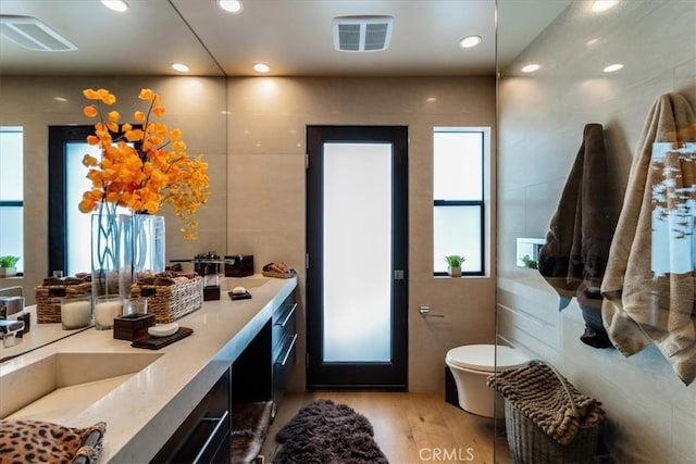 bathroom featuring hardwood / wood-style floors, vanity, and toilet